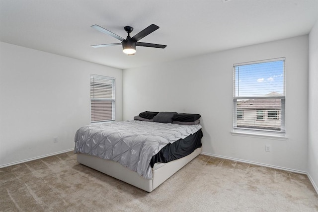 bedroom with baseboards, carpet floors, and ceiling fan