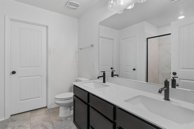 bathroom featuring an enclosed shower, visible vents, toilet, and a sink