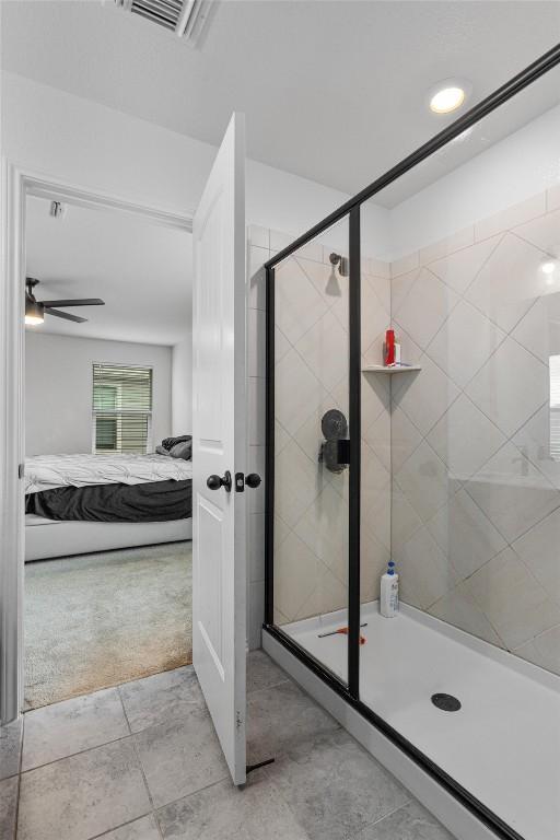 bathroom with a shower with door