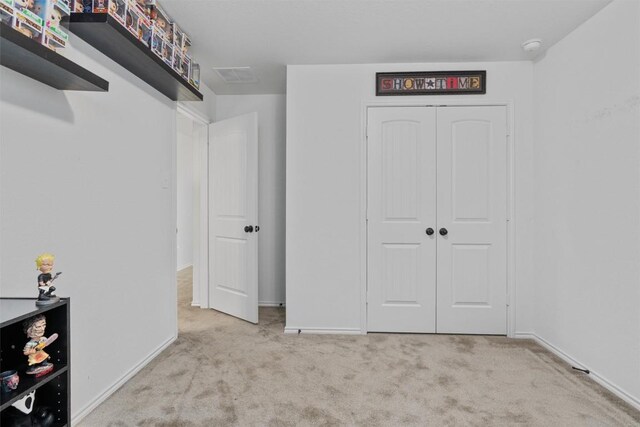 interior space with light colored carpet and a closet