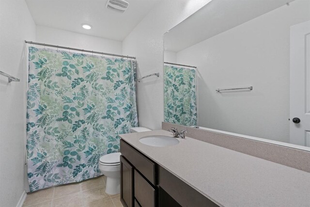 bathroom with vanity, tile patterned floors, and toilet