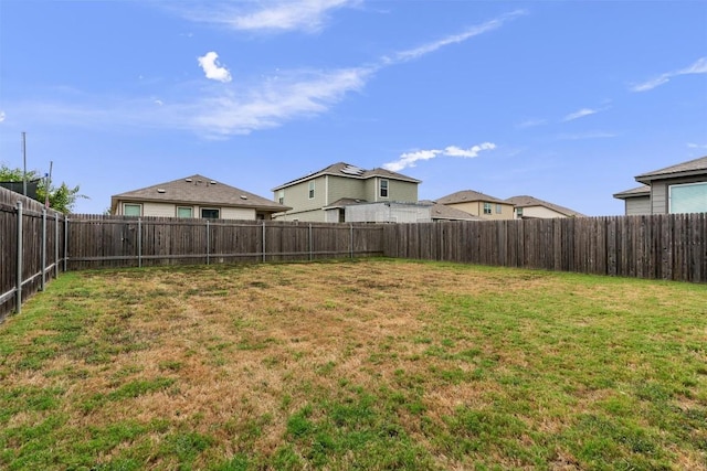 view of yard with a fenced backyard