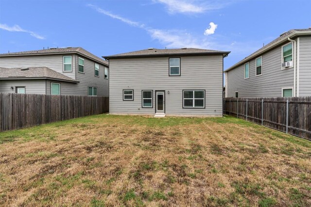 rear view of property with a yard