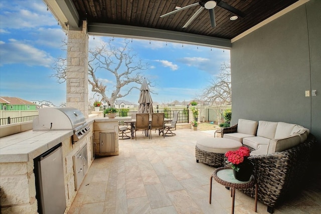 view of patio with a grill, an outdoor kitchen, an outdoor living space, and ceiling fan