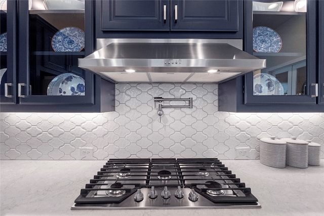 kitchen featuring blue cabinets, ventilation hood, and stainless steel gas cooktop