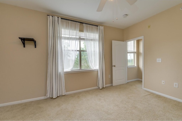 unfurnished bedroom with multiple windows, ceiling fan, and light carpet