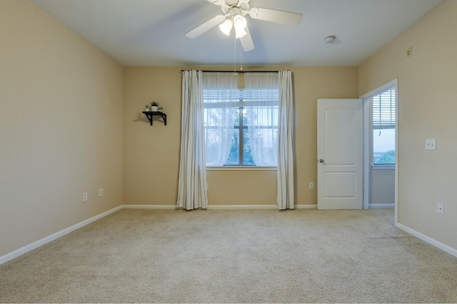 unfurnished room featuring ceiling fan and light colored carpet