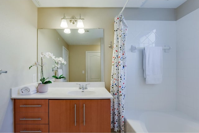 bathroom featuring shower / bath combination with curtain and vanity