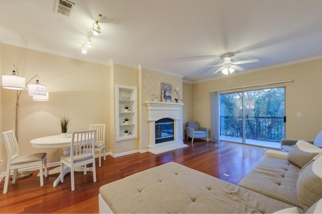 living room featuring crown molding, rail lighting, ceiling fan, and dark hardwood / wood-style floors