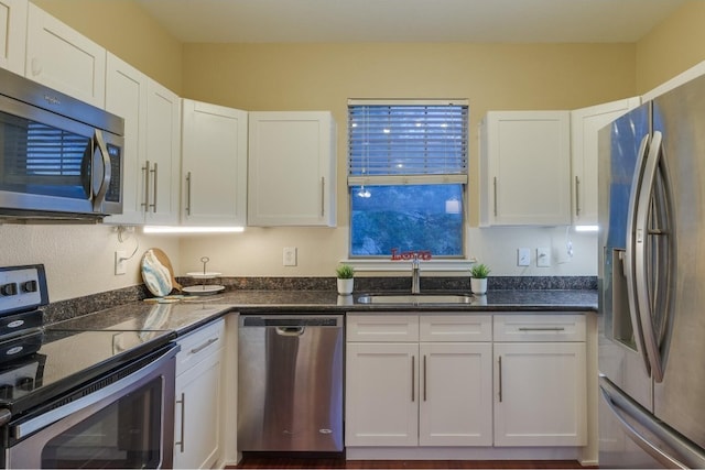 kitchen featuring sink, appliances with stainless steel finishes, and white cabinetry