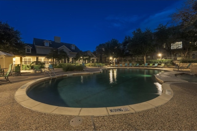 pool at twilight with a patio