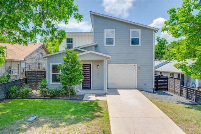 view of front of property with a front yard and a garage