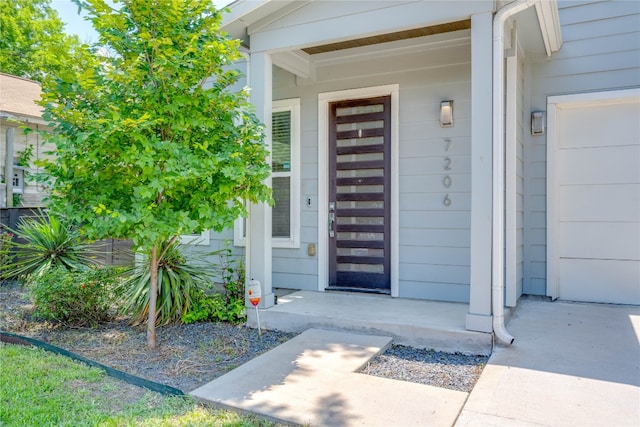 view of exterior entry featuring a garage