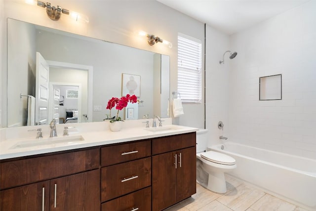 full bathroom with tiled shower / bath combo, toilet, and vanity