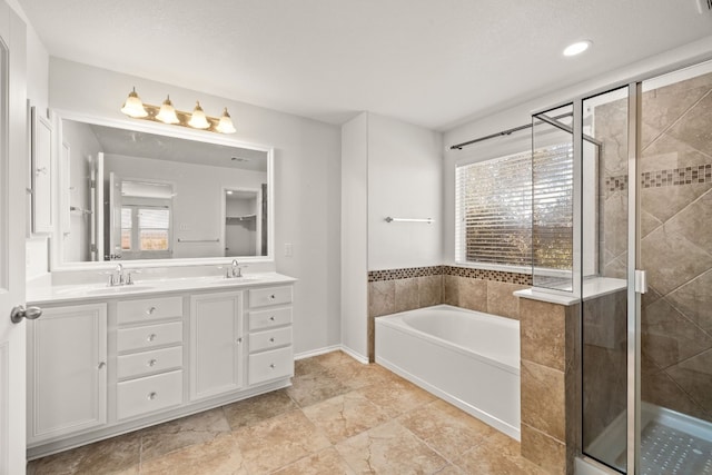 bathroom featuring vanity and shower with separate bathtub