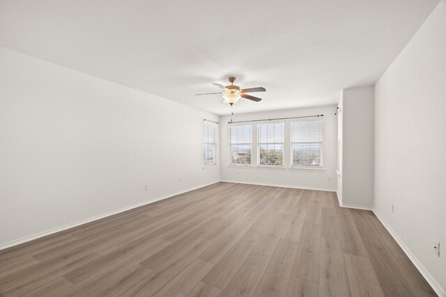 spare room featuring hardwood / wood-style floors and ceiling fan