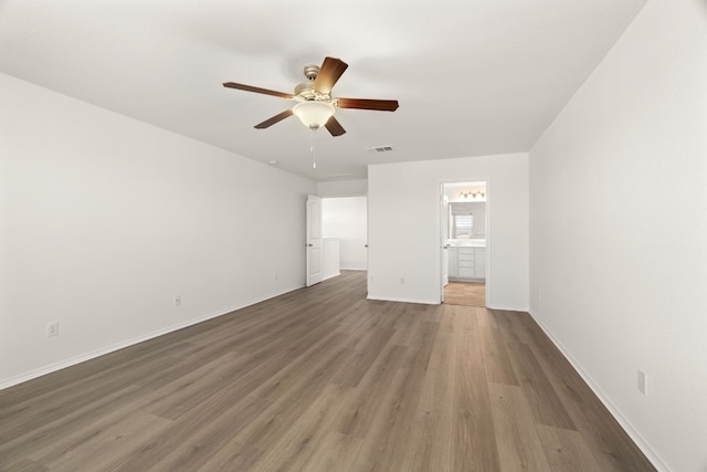 empty room with hardwood / wood-style floors and ceiling fan