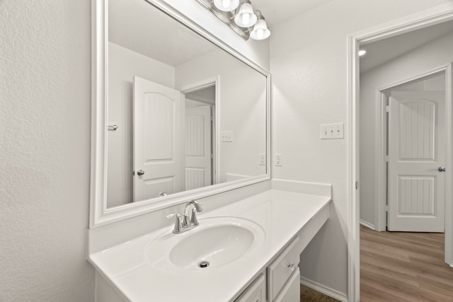 bathroom featuring vanity and hardwood / wood-style floors