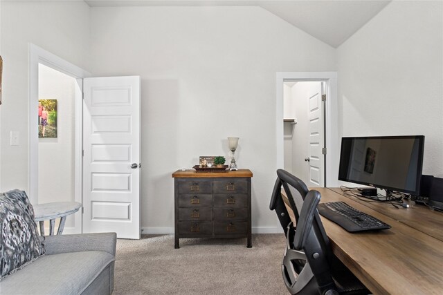 carpeted home office featuring lofted ceiling