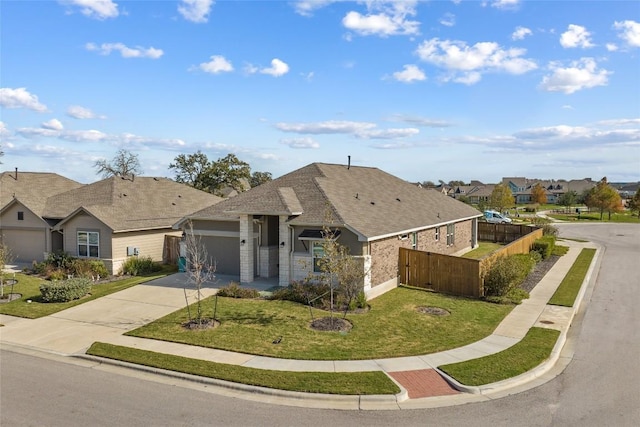 ranch-style house with fence, driveway, roof with shingles, a front lawn, and a garage