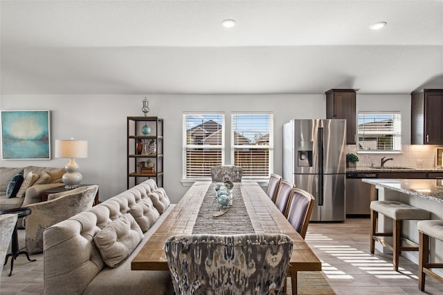 dining space with sink and light hardwood / wood-style floors