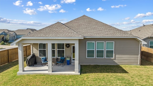 back of house featuring a patio area and a yard