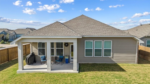 103 Samuel Blair Pass, Bastrop, TX 78602 - rear view of house featuring a fenced backyard, a shingled roof, and a patio area