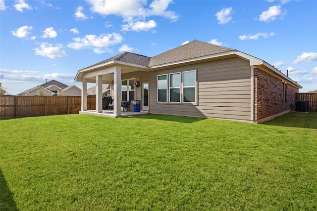 103 Samuel Blair Pass, Bastrop, TX 78602 - back of house with a patio area, a fenced backyard, brick siding, and a shingled roof
