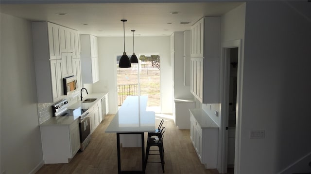 kitchen featuring white electric range, sink, white cabinetry, dark hardwood / wood-style floors, and backsplash