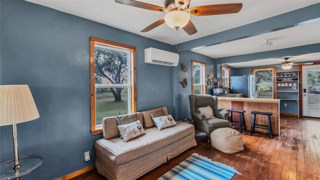 living room featuring a wall mounted AC, dark wood-type flooring, and ceiling fan