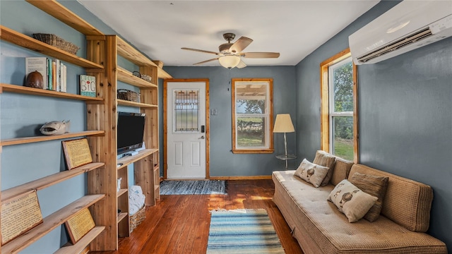 living room featuring ceiling fan, dark hardwood / wood-style flooring, and an AC wall unit