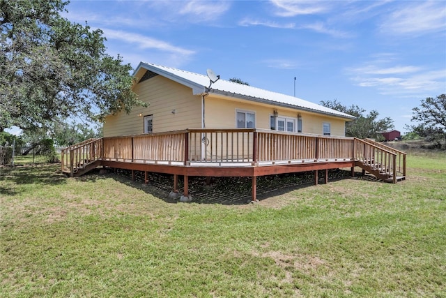 rear view of house featuring a yard and a wooden deck