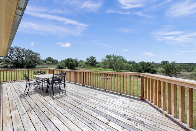 wooden terrace featuring a lawn