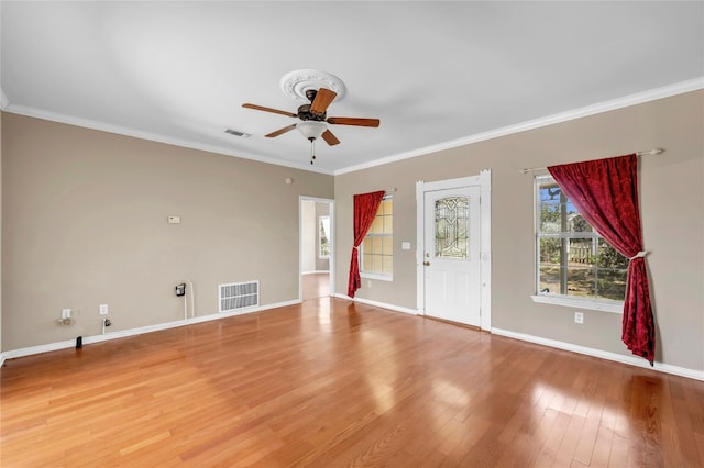 spare room featuring hardwood / wood-style floors, ceiling fan, and ornamental molding