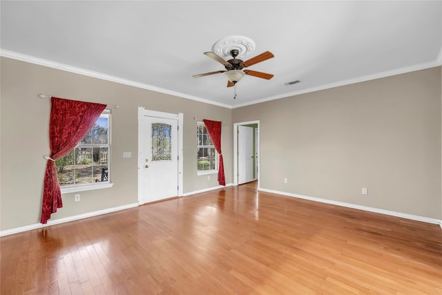 spare room featuring crown molding, ceiling fan, and light hardwood / wood-style floors