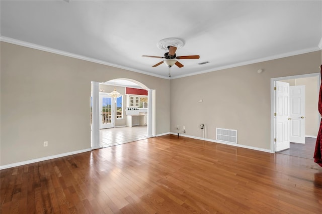 spare room with ornamental molding, hardwood / wood-style flooring, and ceiling fan