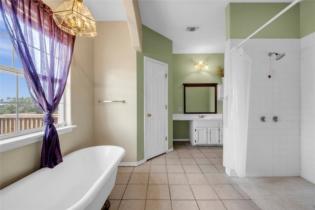 bathroom with plus walk in shower, tile patterned floors, a notable chandelier, and vanity