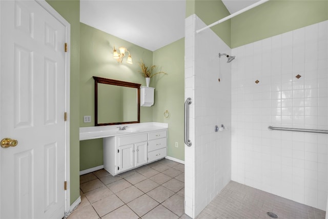 bathroom featuring tiled shower, vanity, and tile patterned floors