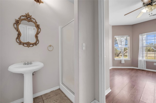 bathroom with hardwood / wood-style flooring and ceiling fan