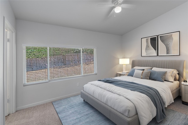 bedroom with ceiling fan, light carpet, and vaulted ceiling