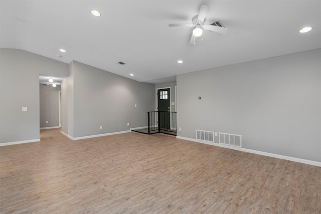 spare room featuring lofted ceiling, ceiling fan, and light hardwood / wood-style flooring