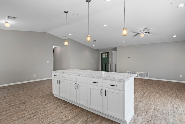 kitchen featuring ceiling fan, decorative light fixtures, light wood-type flooring, and white cabinetry