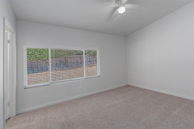 spare room featuring ceiling fan and light carpet