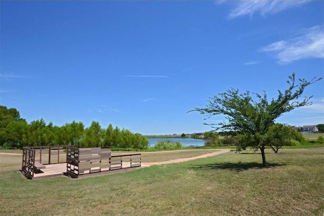 view of property's community with a yard and a water view