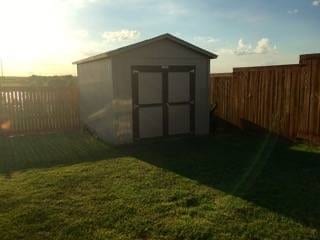 outdoor structure at dusk with a yard