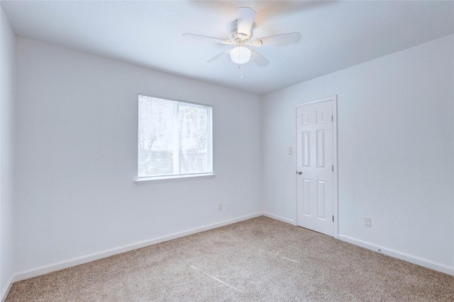 empty room with ceiling fan and light colored carpet