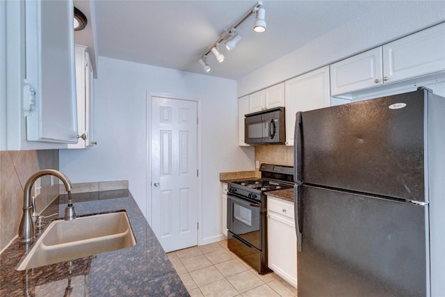 kitchen with black appliances, dark stone countertops, white cabinetry, and sink