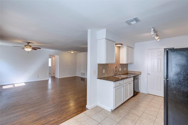 kitchen with black appliances, white cabinets, sink, ceiling fan, and tasteful backsplash