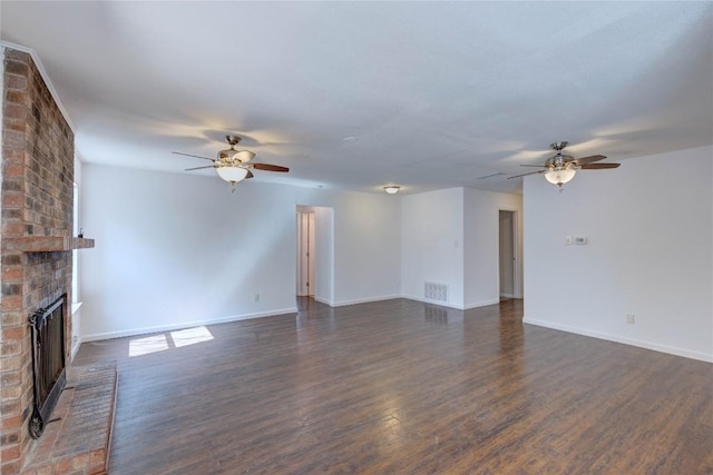 unfurnished living room with ceiling fan, dark hardwood / wood-style floors, and a brick fireplace