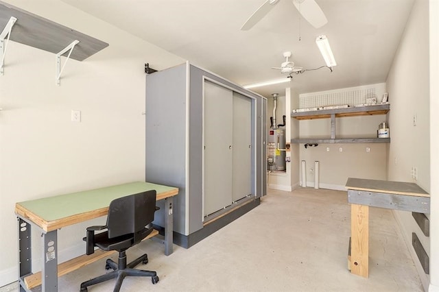 office area with ceiling fan, gas water heater, and concrete flooring